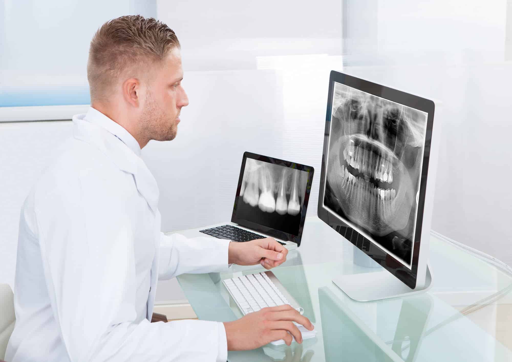 dentist checking out an X-ray image at wilmington dental clinic